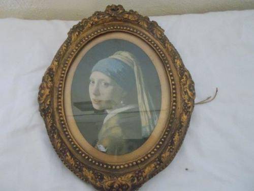 Vintage ornate  oval frame with print of a woman behind glass