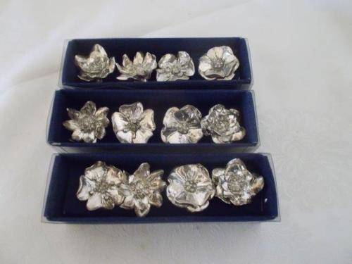 Three nicely boxed silver plated looking serviette holders