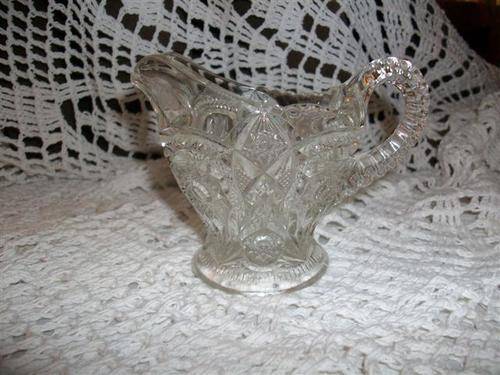 Small and lovely pressed glass gravy jug