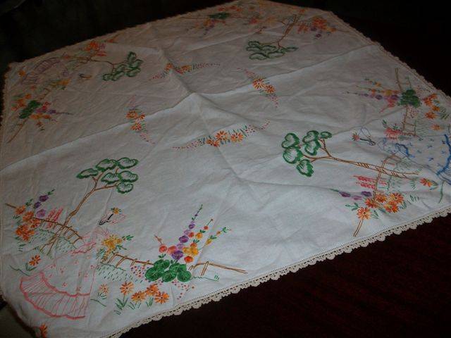 Vintage embroidered small table cloth with a vintage lady in garden scene