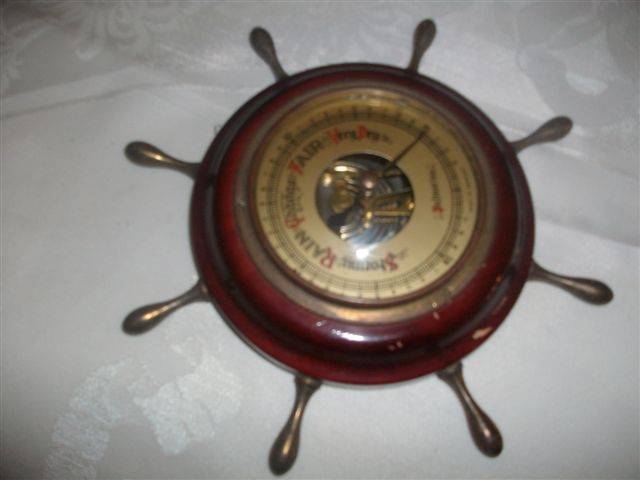 In a form of ships wheel small wooden barometer made in germany