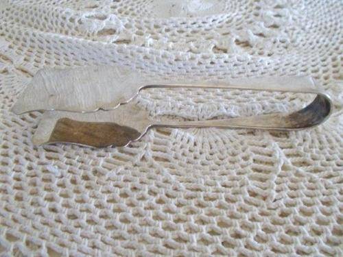 a pair of sliver plated tongs