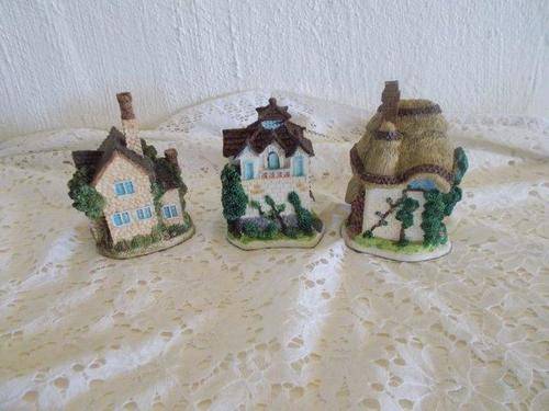 A collection of three small cottage homes ornaments