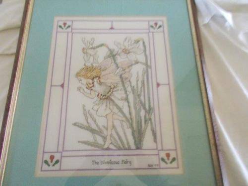 Framed behind glass the narcissus fairy taperstry