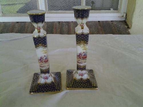 A pair of pretty decorative porcelain candle stick holders