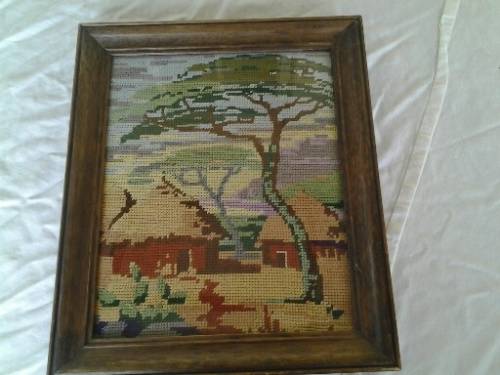small framed nice zulu hut scene taperstry behind glass
