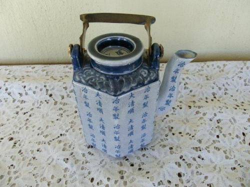 stunning oriental blue porcelain tea pot with a brass handle