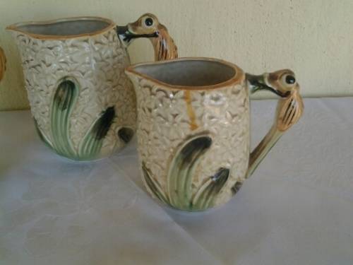 A set of three vintage bee style porcelain decorative porcelain jugs