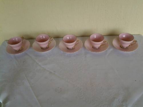 a lot of five pretty small pastel pink espresso coffee cups and saucers