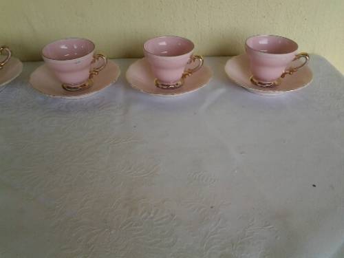 a lot of five pretty small pastel pink espresso coffee cups and saucers