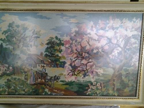 large country side scene tapestry behind glass