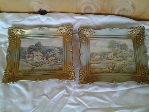 A pair of small pretty hard plastic ornate frames with painted home scenes