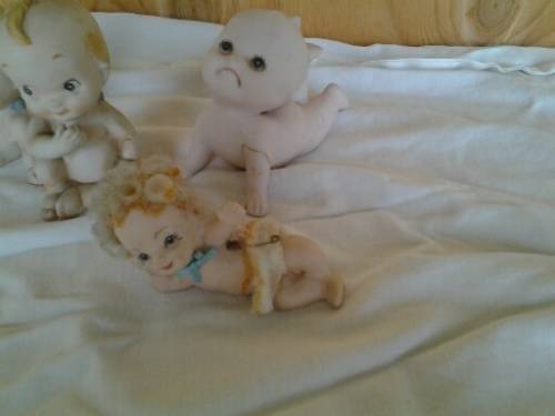 A collection of some  collectable Bisque kewpie style baby ornaments