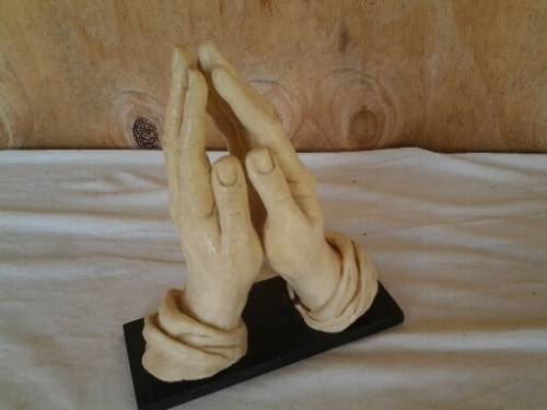 A nice vintage resin religious praying hands on base
