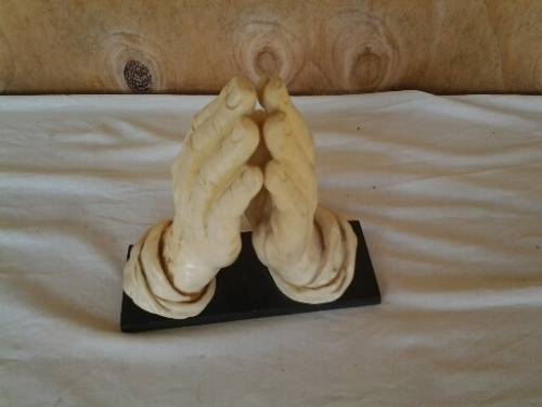 A nice vintage resin religious praying hands on base