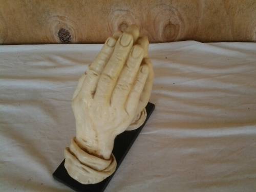 A nice vintage resin religious praying hands on base