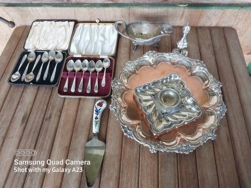 A lot of vintage sliver plated tea spoons ..tray ..tea strainer etc