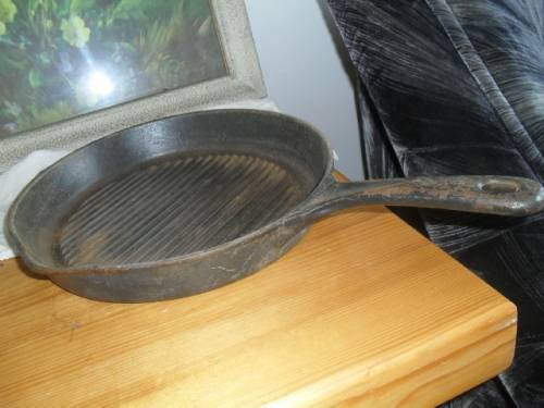 A CAST IRON PAN - 46cm long including handle  pan 29cm x 28cm  4cm deep