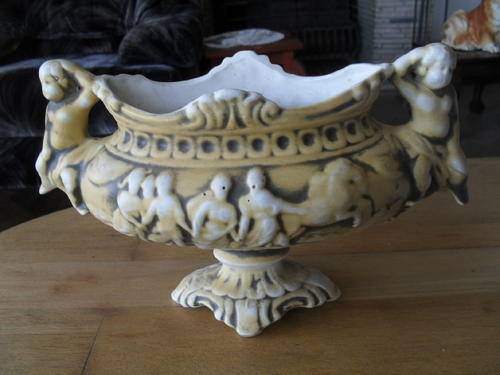 A CAPODIMONTE? not to sure -lovely piece anyway.  OVAL URN WITH ANGELS AS HANDLES.