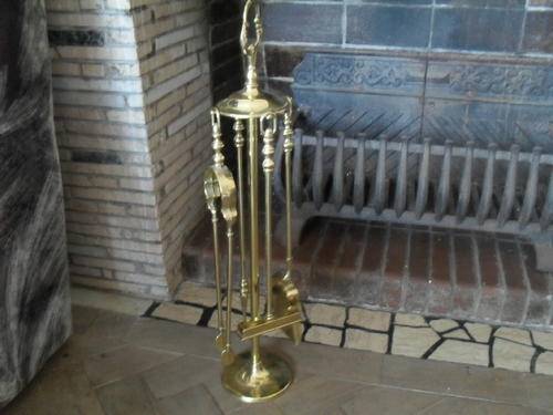 A BRASS FIRE PLACE UTENSILS on a STAND. - highest point 58cm, base 12cm wide.
