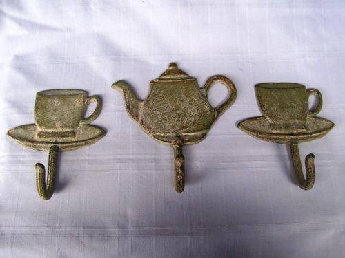 CAST IRON HOOKS. TEA CUPS AND POT