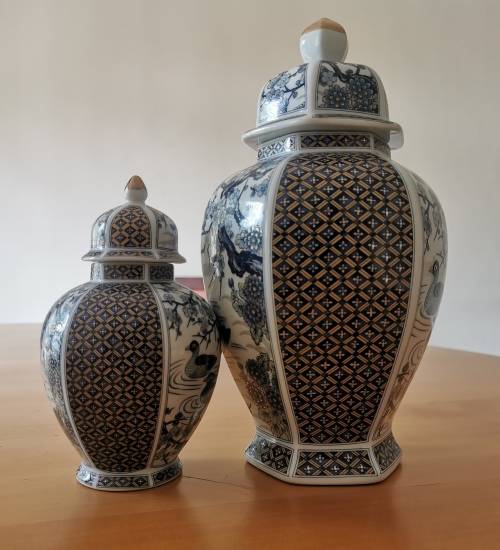 Japanese Meiji style Vases with lids on wooden bases.