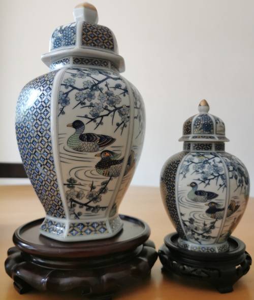 Japanese Meiji style Vases with lids on wooden bases.
