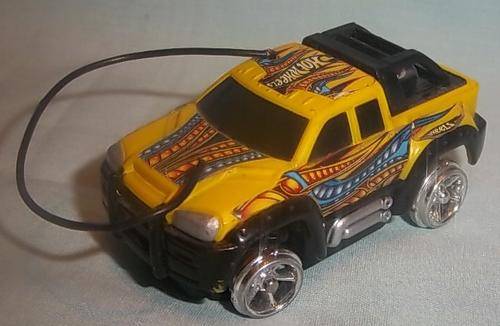 A YELLOW HOTWHEELS CAR WITH A ARIAL