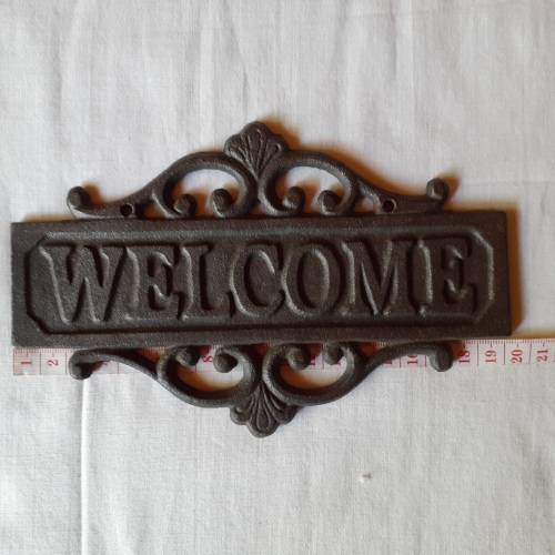 Cast Iron `WECOME` sign.