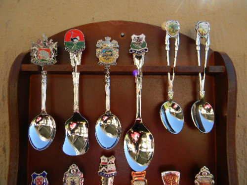 18 Souvenir  spoons  in good condition with free rack  as per pictures