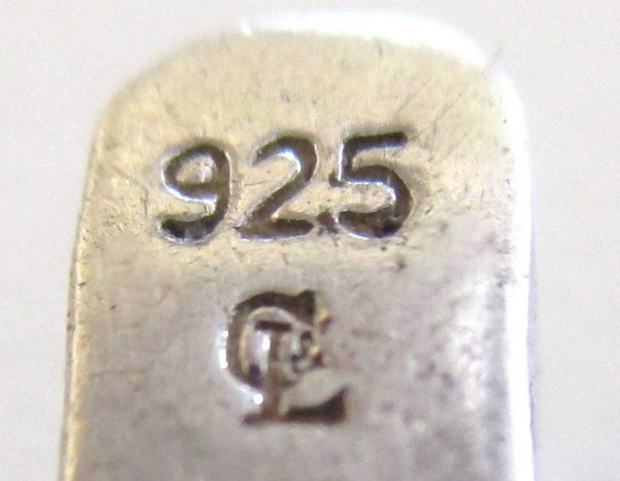 A SOLID SILVER TENNIS BRACELET WITH A WELL MADE CLASP--PLEASE SEE ALL IMAGES