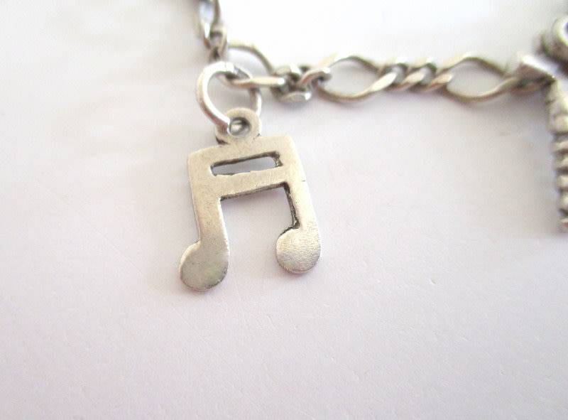 A SOLID SILVER CHARM BRACELET