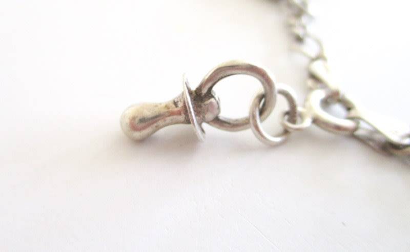 A SOLID SILVER CHARM BRACELET