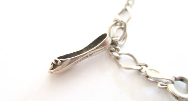 A SOLID SILVER CHARM BRACELET