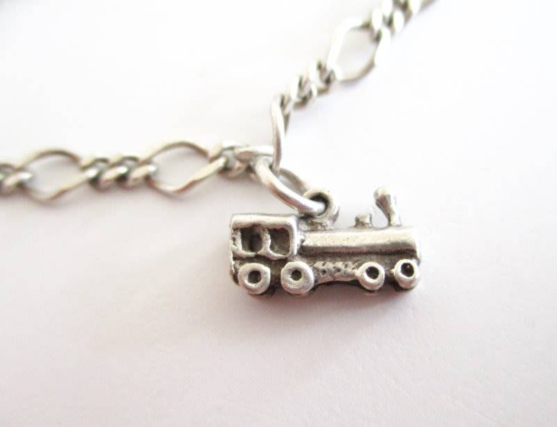 A SOLID SILVER CHARM BRACELET