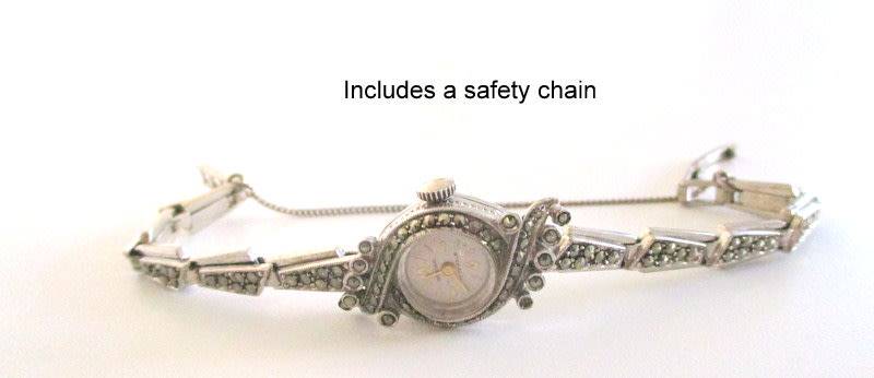 A STERLING SILVER MARCASITE (ALL INTACT) WATCH IN WORKING ORDER AND KEEPING TIME