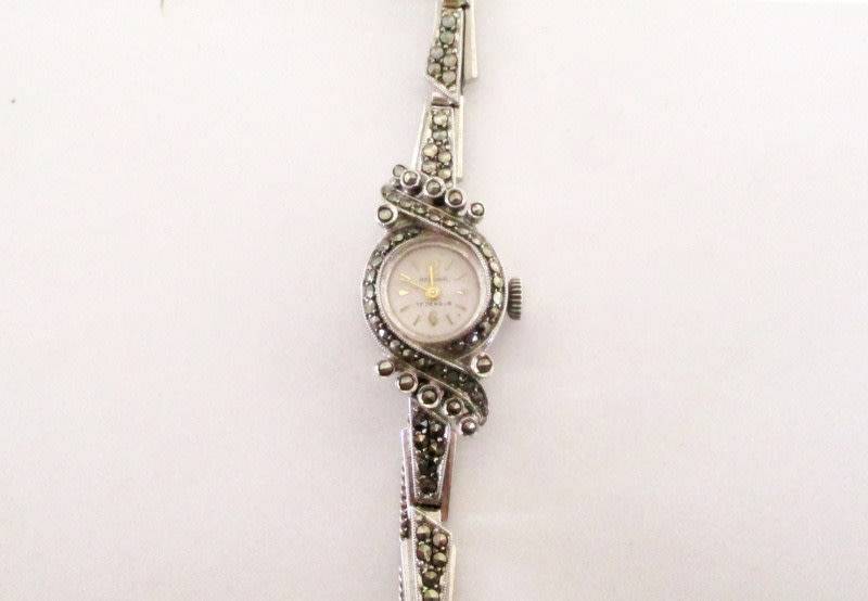 A STERLING SILVER MARCASITE (ALL INTACT) WATCH IN WORKING ORDER AND KEEPING TIME