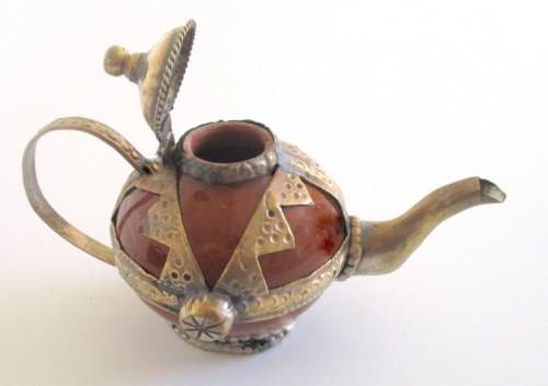 A METAL AND CERAMIC TEA POT AND A POTTERY TEA POT