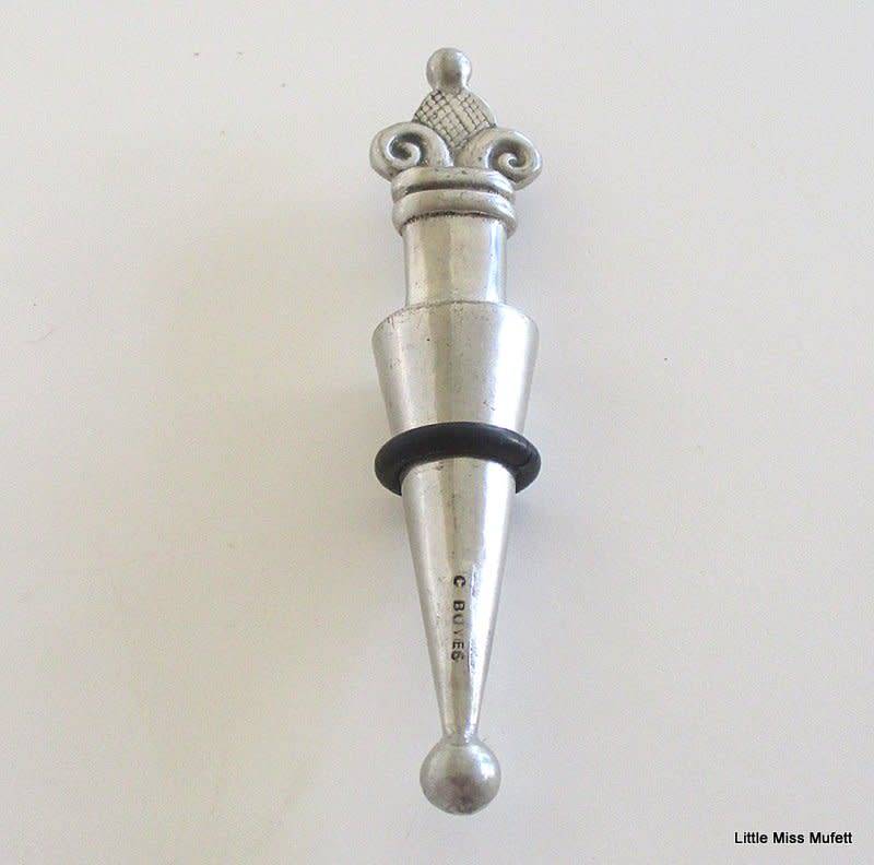 A CARROL BOYES WINE STOPPER WITH ORIGINAL RUBBER RING