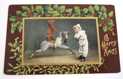 AN ANTIQUE POSTCARD OF A CHILD AND HIS BEAR