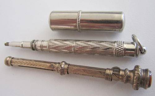 2 VINTAGE PROPELLING PENCILS AND A CONTAINER WITH LEADS