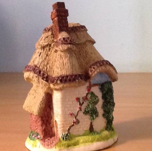Vintage ornament of a country thatched cottage in fine detail