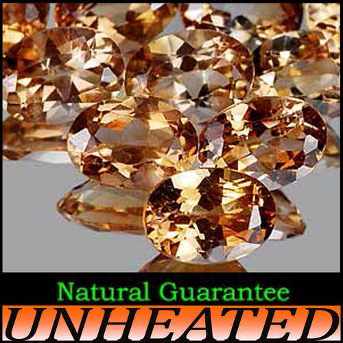 IMPERIAL LIGHT BRANDY TOPAZ, AN OVAL POLISHED UNHEATED GEMS