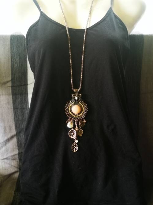 Beautiful necklace with bulky pendant and charms