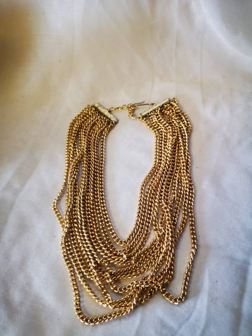 Stunning gold tone multi string necklace