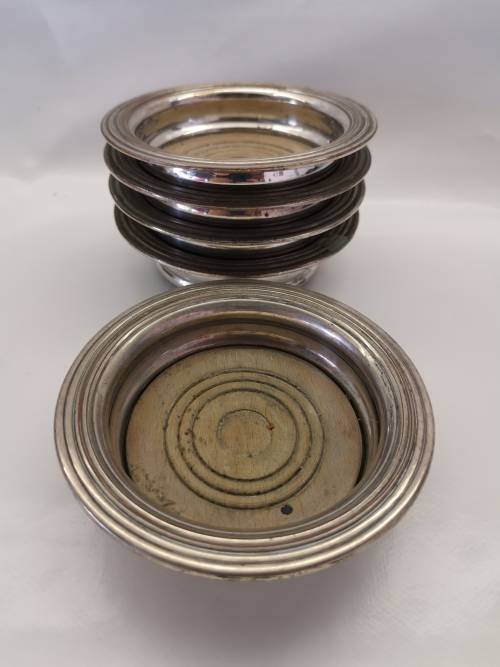 FIVE VICTORIAN SILVERPLATE BOTTLE COASTERS
