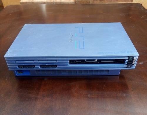 Sony Playstation PS2 gaming console with 4 controllers.