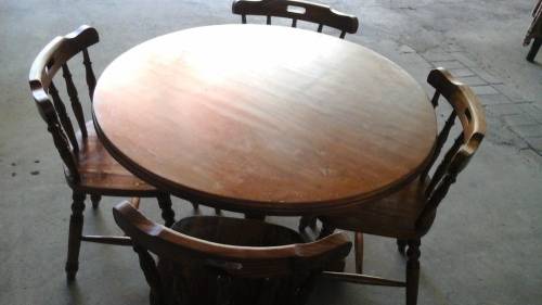 IT MIGHT BE PINE BUT IT IS A BEAUTIFUL SOLID DARK STAINED AND VARNISHED ROUND TABLE AND FOUR CHAIRS