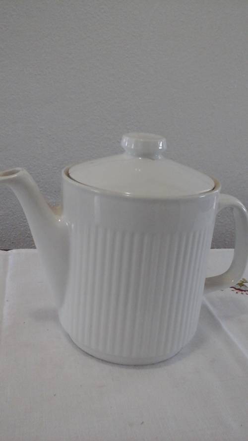A LARGE MAJESTIC WHITE TEA POT. HAS A RIBBED PATTERN. MAGNIFICENT PIECE