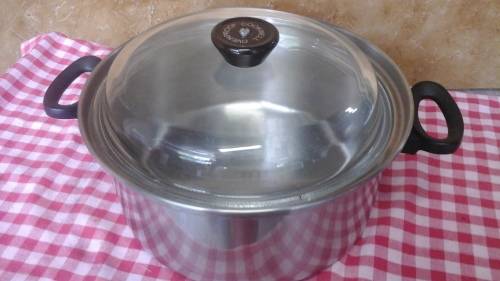 A STUNNING STAINLESS STEEL SMALL SAUCEPAN THAT HAS TWO HANDLES. THE LID IS GLASS AND STAINLESS